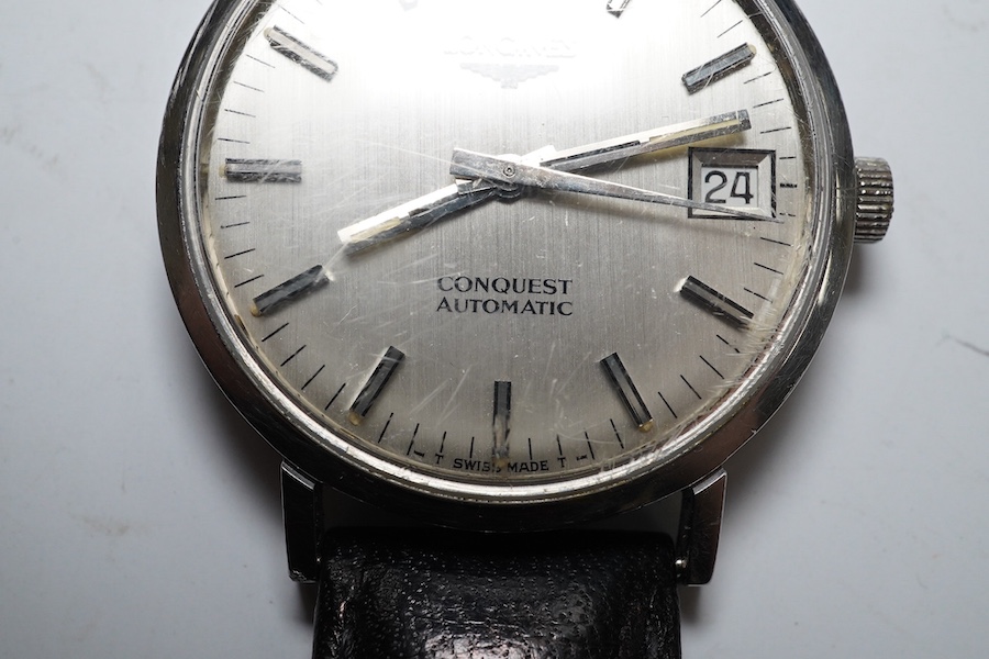 A gentleman's stainless steel Longines Conquest Automatic wrist watch, on an associated leather strap, case diameter 35mm. Condition - poor to fair